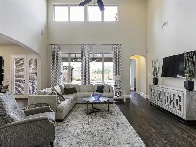 a living room with furniture and wooden floor
