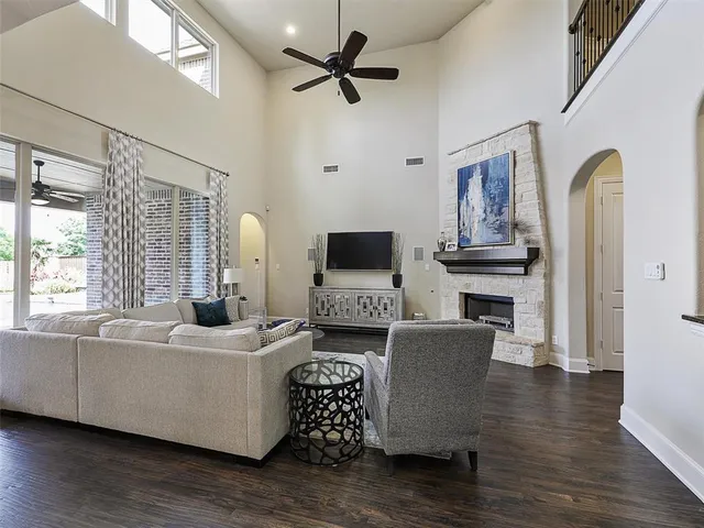 a living room with furniture fireplace and flat screen tv