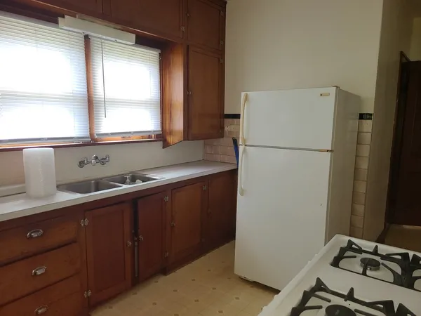 a white refrigerator freezer sitting inside of a kitchen