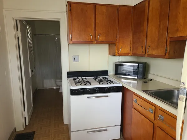 a kitchen with stainless steel appliances granite countertop a stove a refrigerator and a sink