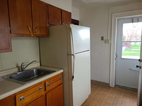 a kitchen with stainless steel appliances white cabinets and a sink
