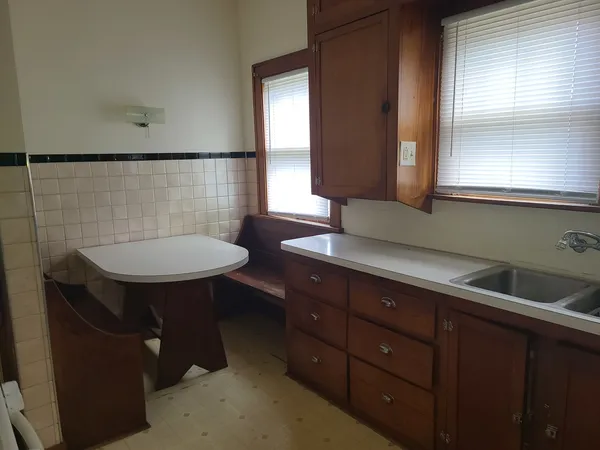a bathroom with a sink a toilet and a window