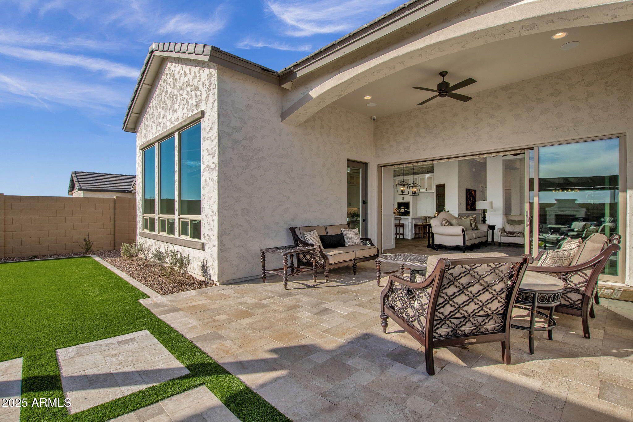 2626 East Russell Street Mesa, AZ 85213 - Photo 13 of 25 a view of a patio with couches chairs and wooden floor