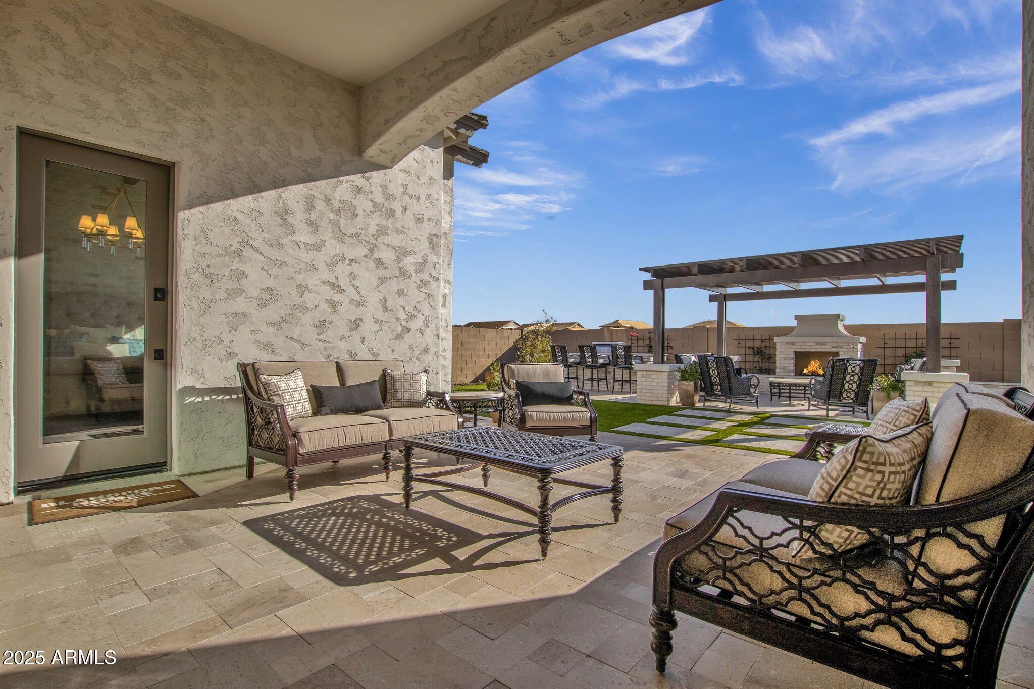 2626 East Russell Street Mesa, AZ 85213 - Photo 14 of 25 a view of a patio with dining table and chairs with wooden floor