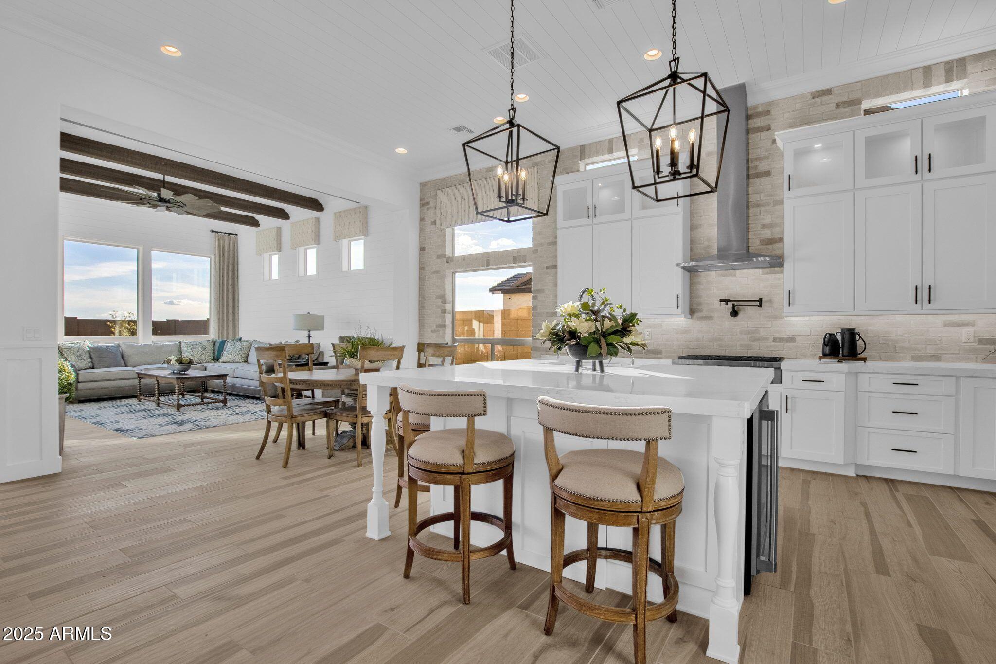 2626 East Russell Street Mesa, AZ 85213 - Photo 2 of 25 a view of a dining room with furniture and wooden floor
