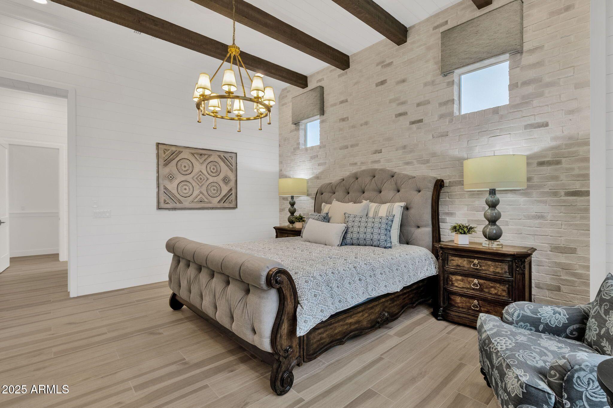 2626 East Russell Street Mesa, AZ 85213 - Photo 7 of 25 a spacious bedroom with a bed and a couch