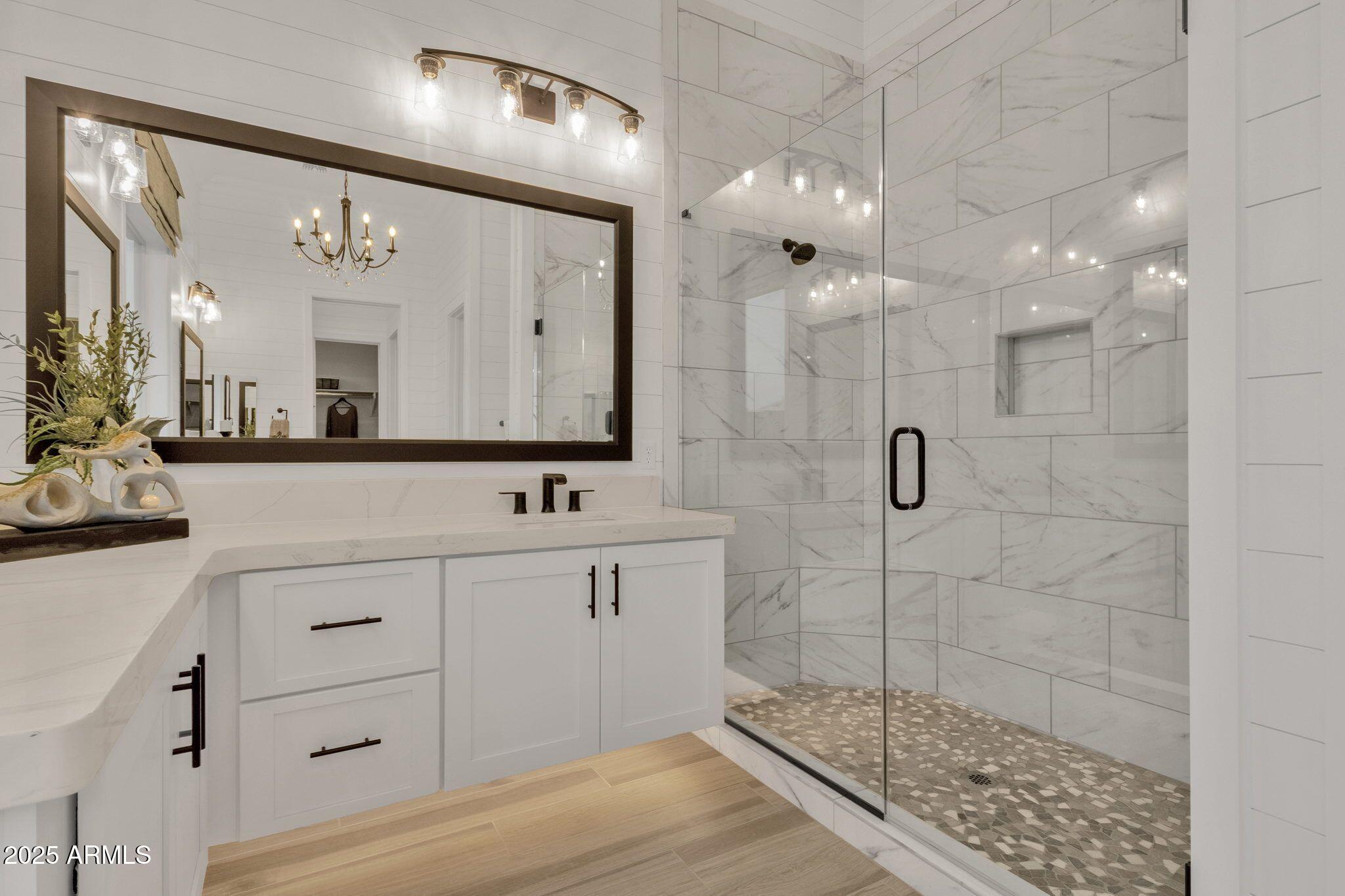 2626 East Russell Street Mesa, AZ 85213 - Photo 9 of 25 a bathroom with a double vanity sink mirror and shower