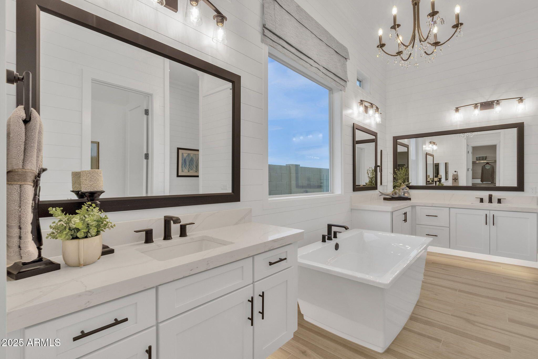 2626 East Russell Street Mesa, AZ 85213 - Photo 10 of 25 a bathroom with double vanity sinks a vanity a lamp and a mirror