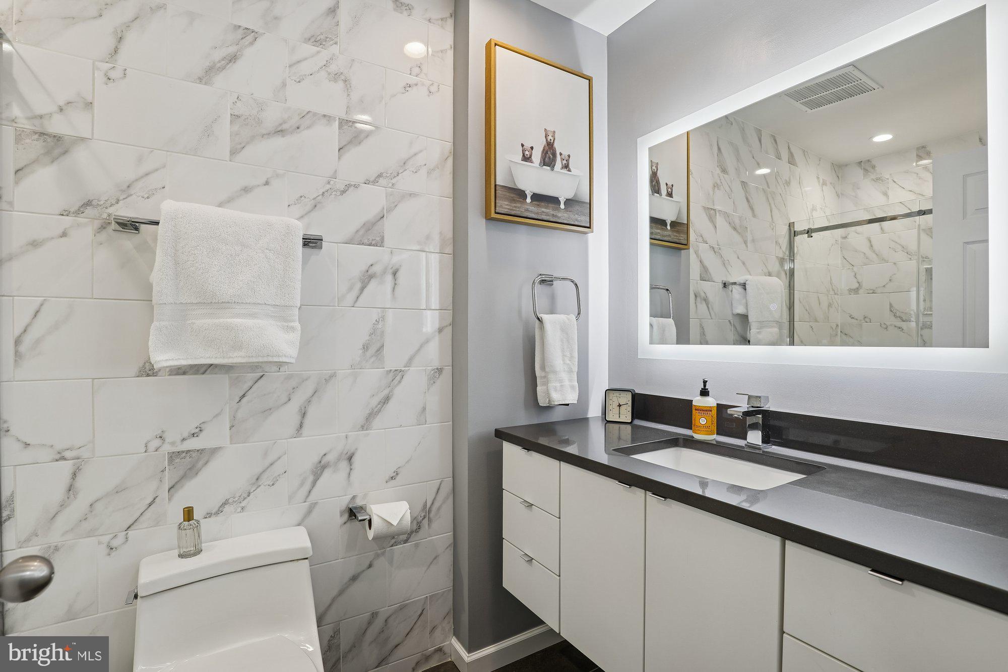 8019 Galla Knoll Circle Springfield, VA 22153 - Photo 35 of 57 a bathroom with a double vanity sink toilet and shower