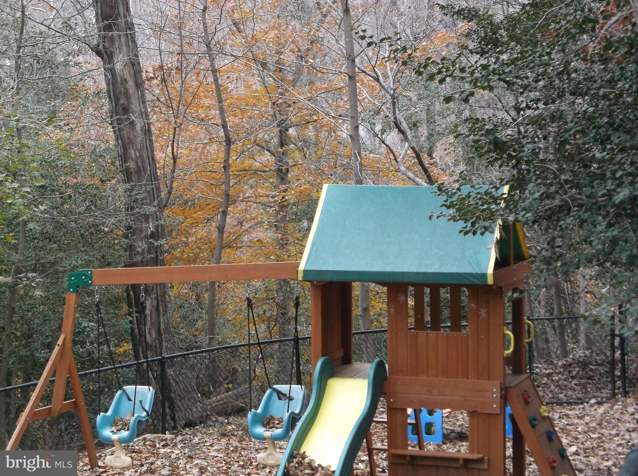 622 Running Fox Road Lusby, MD 20657 - Photo 28 of 46 Play equipment in fenced in yard conveys