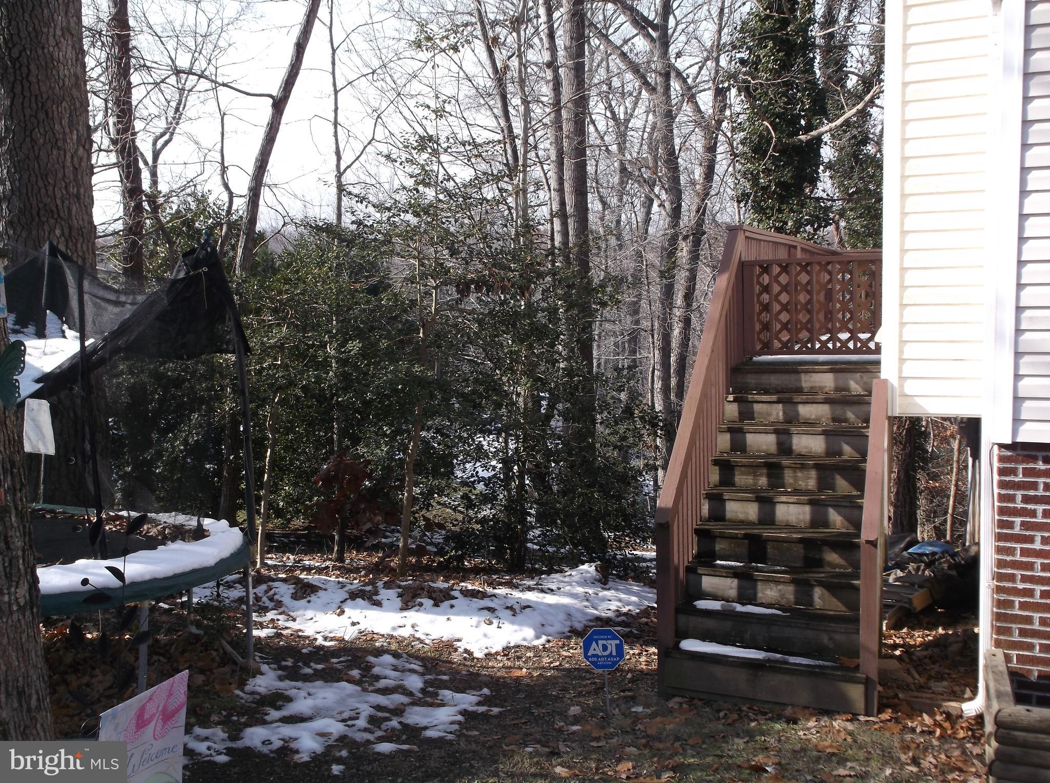 622 Running Fox Road Lusby, MD 20657 - Photo 35 of 46 Side yard is level and has the wrap around stairs