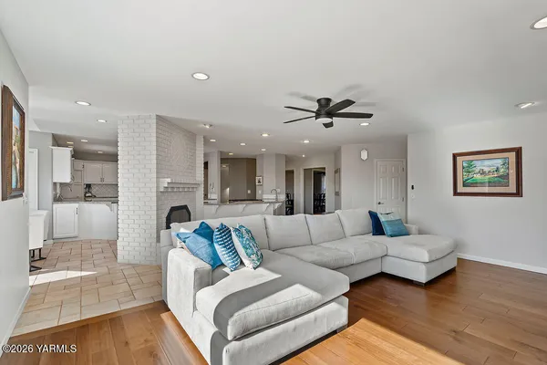 a living room with furniture and a view of kitchen