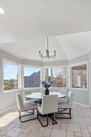 a living room with furniture a table and a large window