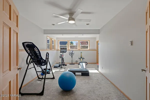 a living room with furniture a chandelier and a rug