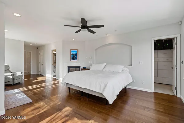a spacious bedroom with a bed and a chandelier