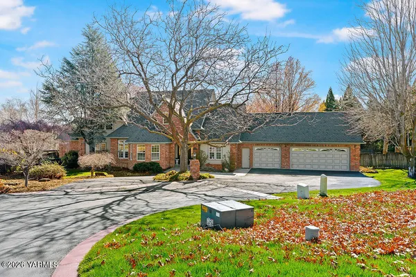 a front view of a house with garden and sitting area