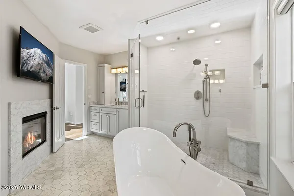 a bathroom with a sink a toilet a shower and a mirror