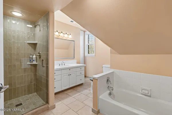 a bathroom with a bathtub sink and mirror
