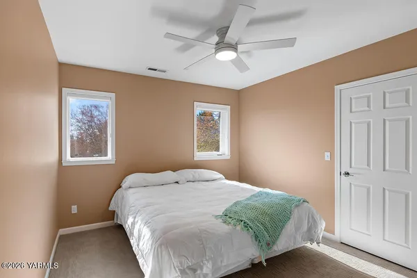 a bedroom with a large bed and a window