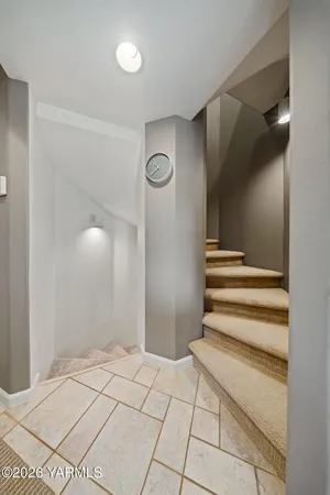 a view of a livingroom with a staircase and a ceiling fan