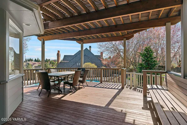 a view of a chairs and table on the deck