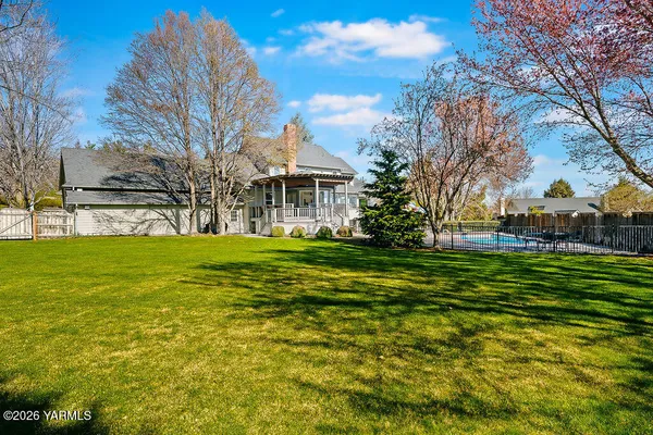 a front view of a house with a yard table and chairs