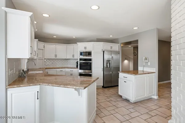 a kitchen with cabinets and stainless steel appliances