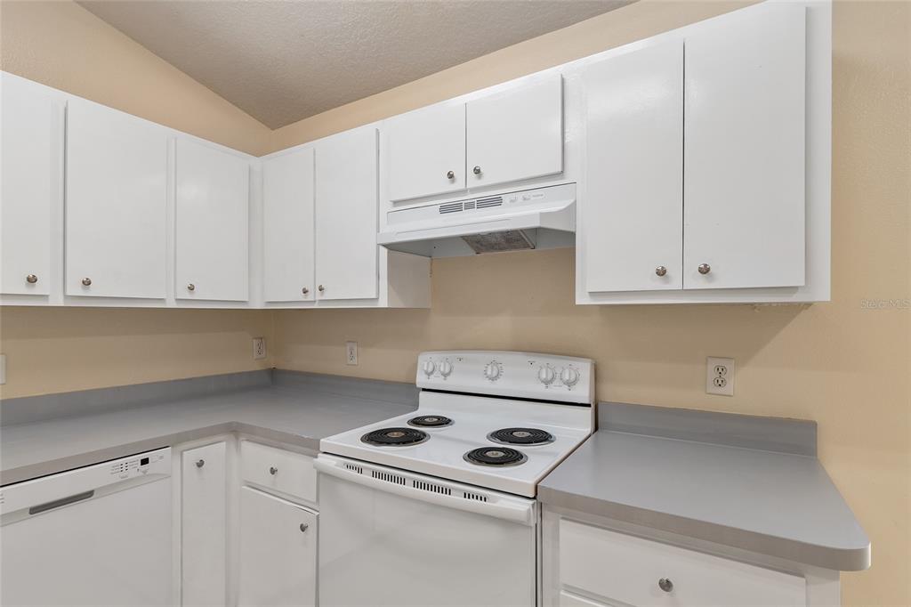 4329 Northwest 155th Street Reddick, FL 32686 - Photo 27 of 52 a kitchen with white cabinets and white appliances