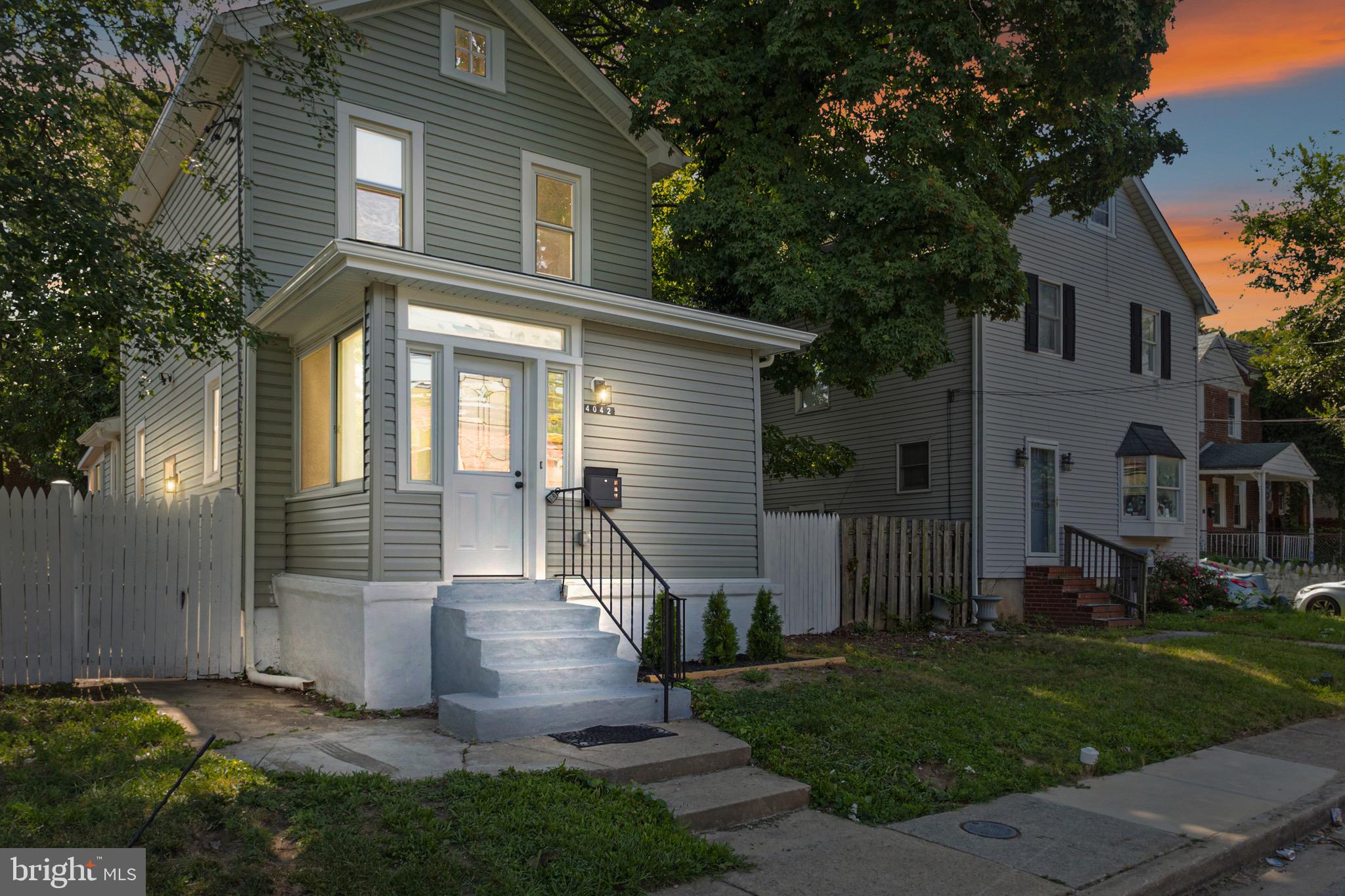 4042 6th Street Baltimore, MD 21225 - Photo 1 of 31 a front view of a house with garden