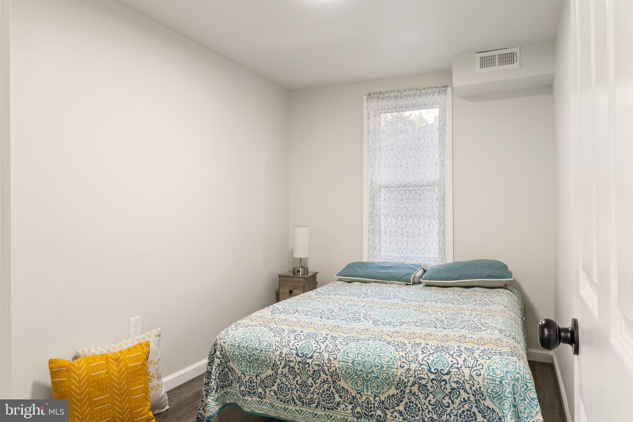 4042 6th Street Baltimore, MD 21225 - Photo 12 of 31 a bedroom with a bed and a window