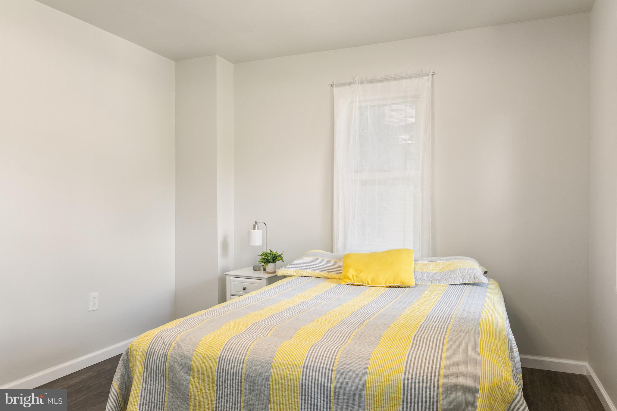 4042 6th Street Baltimore, MD 21225 - Photo 14 of 31 a bedroom with a bed and a closet