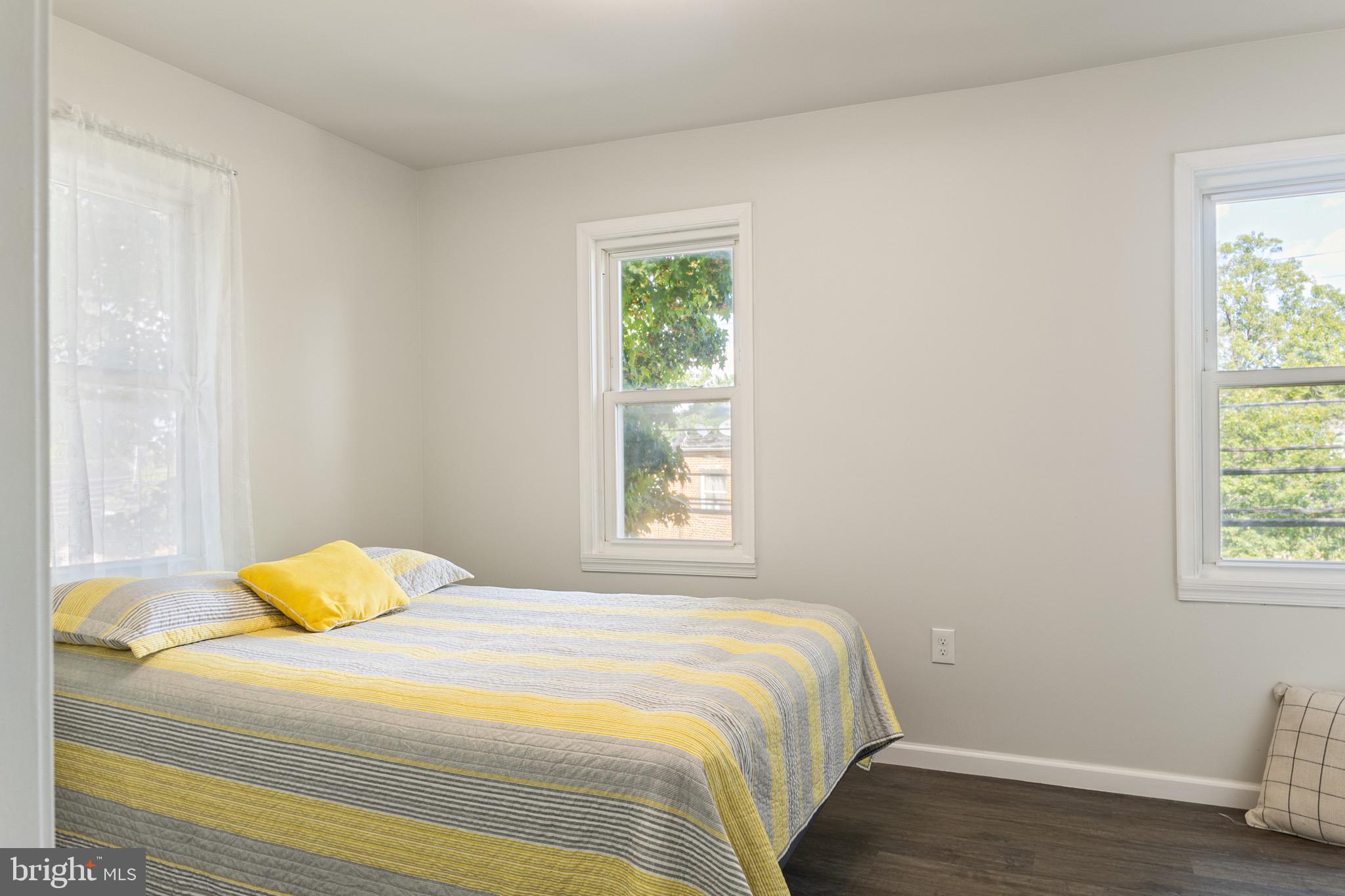 4042 6th Street Baltimore, MD 21225 - Photo 15 of 31 a bedroom with a bed and wooden floor