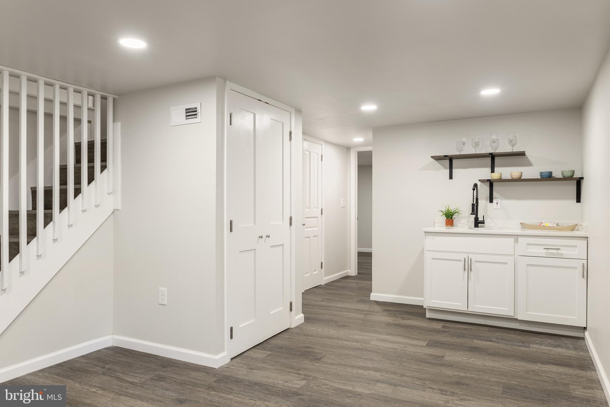 4042 6th Street Baltimore, MD 21225 - Photo 18 of 31 a kitchen with white cabinets and sink