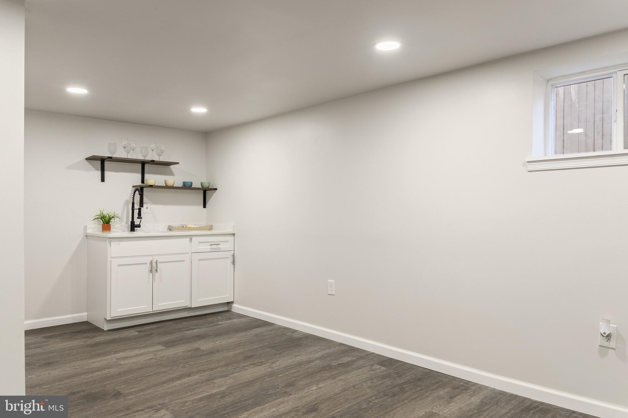 4042 6th Street Baltimore, MD 21225 - Photo 19 of 31 a room with a sink cabinets and wooden floor