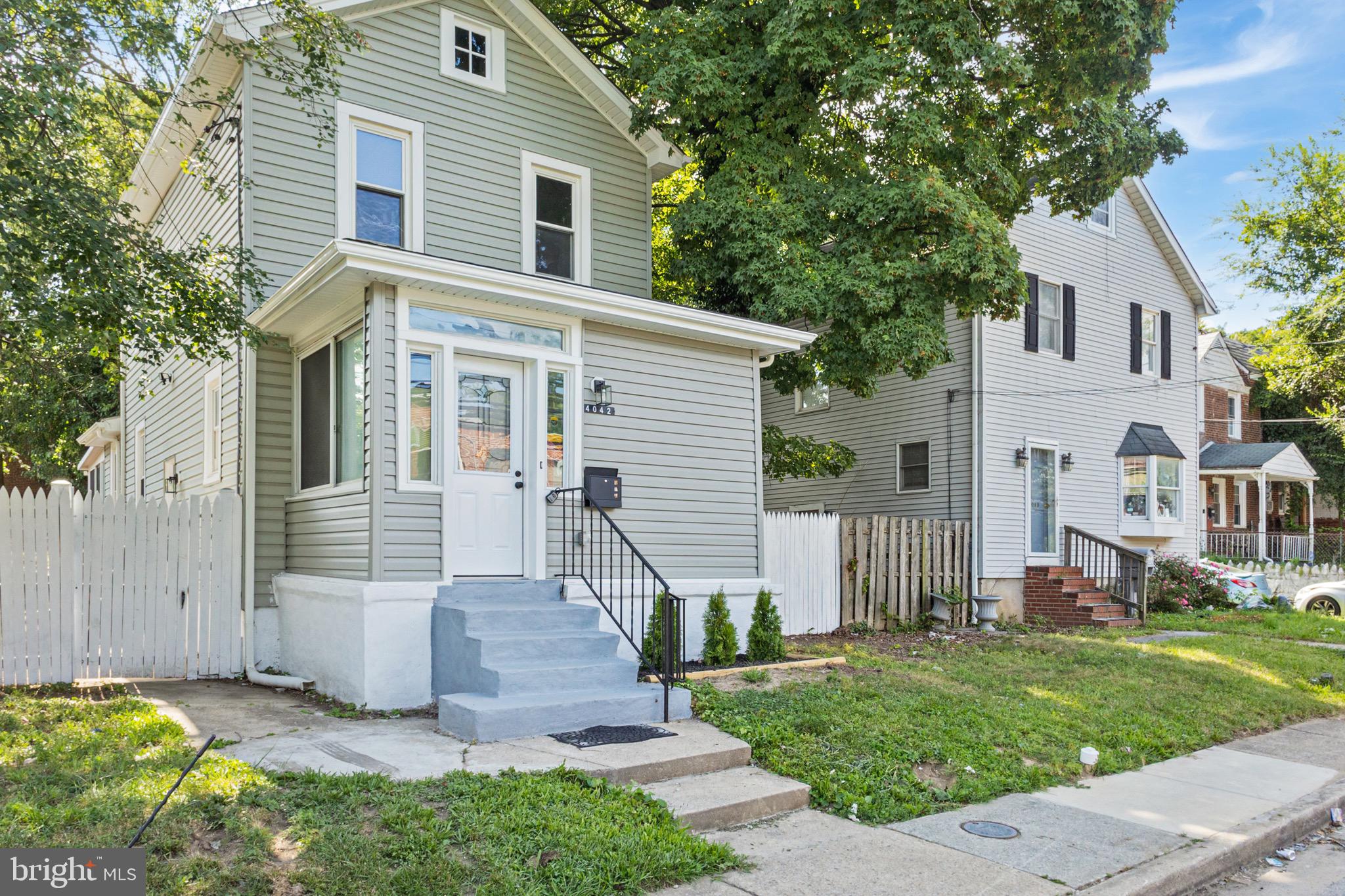 4042 6th Street Baltimore, MD 21225 - Photo 2 of 31 a front view of a house with a garden and plants