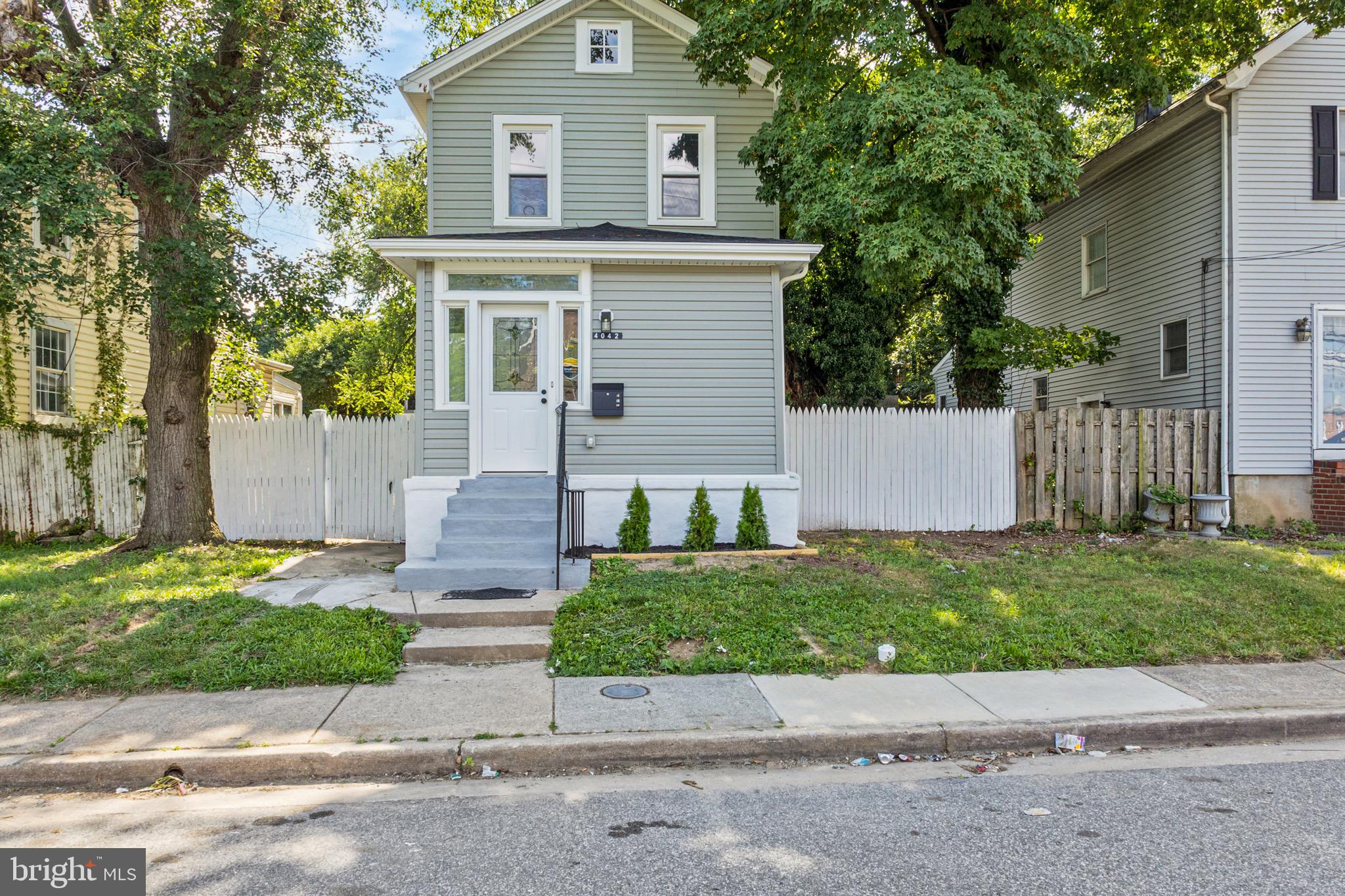 4042 6th Street Baltimore, MD 21225 - Photo 3 of 31 front view of a house with a yard