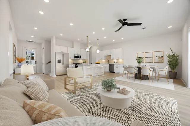 a living room with furniture and a view of kitchen