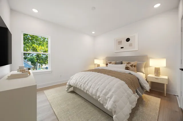 a bedroom with a bed and a window