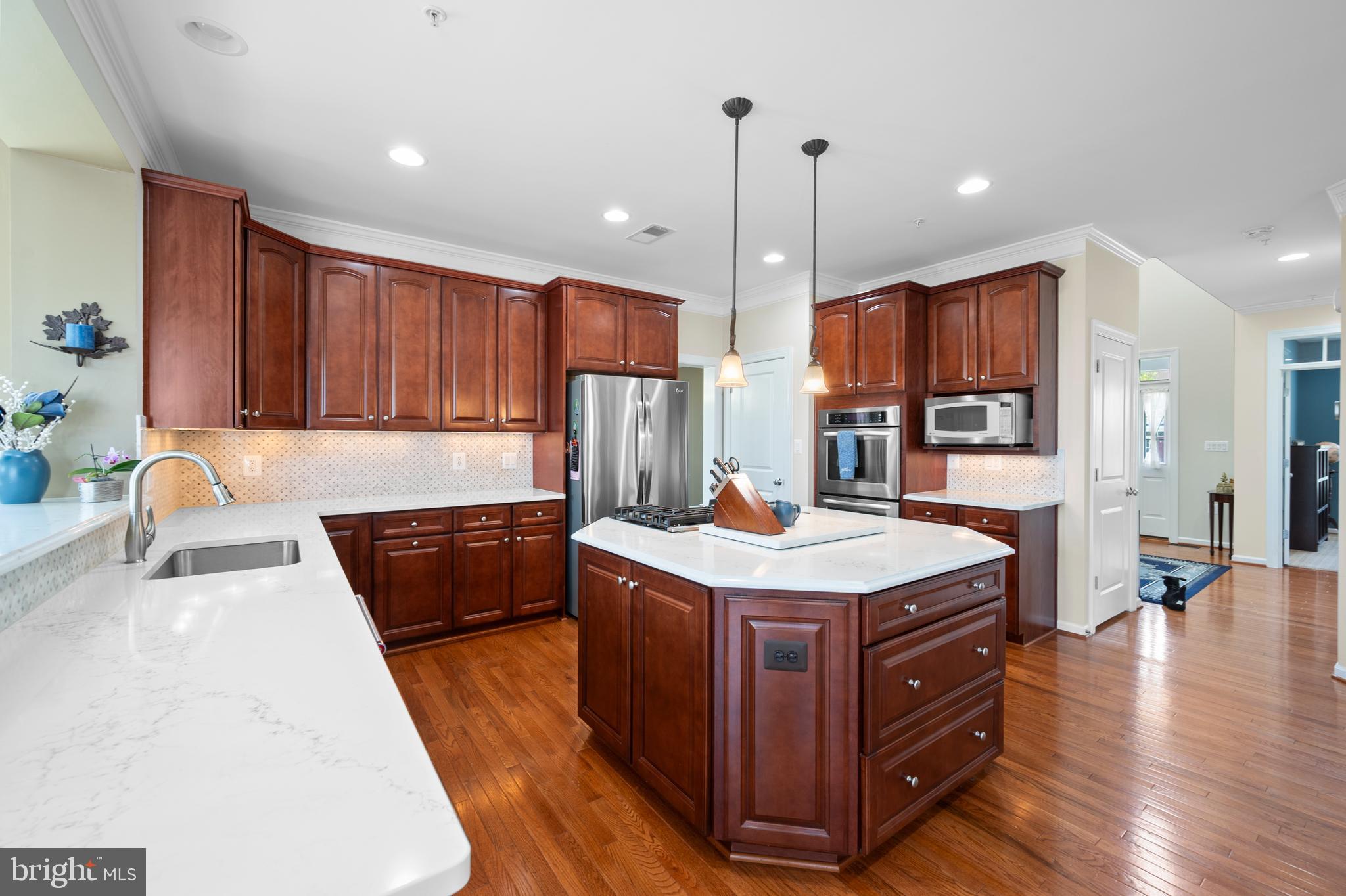 13212 Moonlight Trail Drive Silver Spring, MD 20906 - Photo 20 of 81 a kitchen with stainless steel appliances granite countertop a stove a sink dishwasher and a refrigerator with wooden floor
