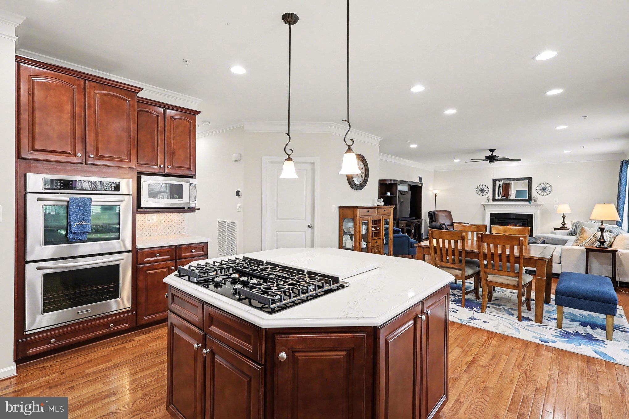 13212 Moonlight Trail Drive Silver Spring, MD 20906 - Photo 21 of 81 a kitchen with a table chairs stove and wooden floor