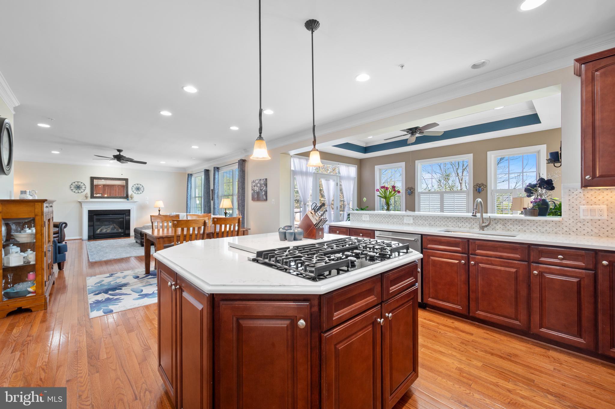 13212 Moonlight Trail Drive Silver Spring, MD 20906 - Photo 23 of 81 a kitchen with stainless steel appliances granite countertop a stove a sink dishwasher and a kitchen island with wooden cabinets