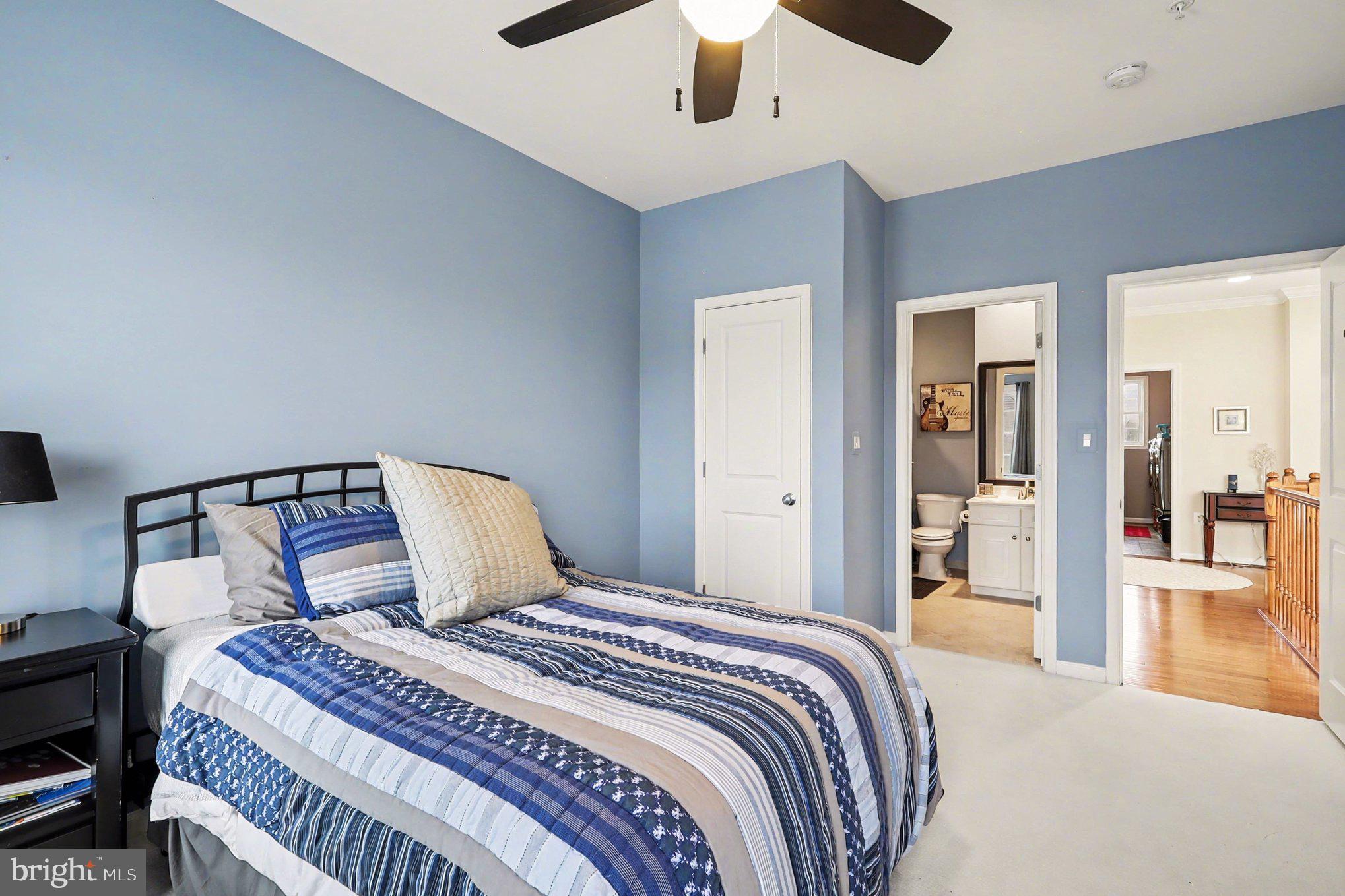 13212 Moonlight Trail Drive Silver Spring, MD 20906 - Photo 51 of 81 a bedroom with a large bed and a chandelier