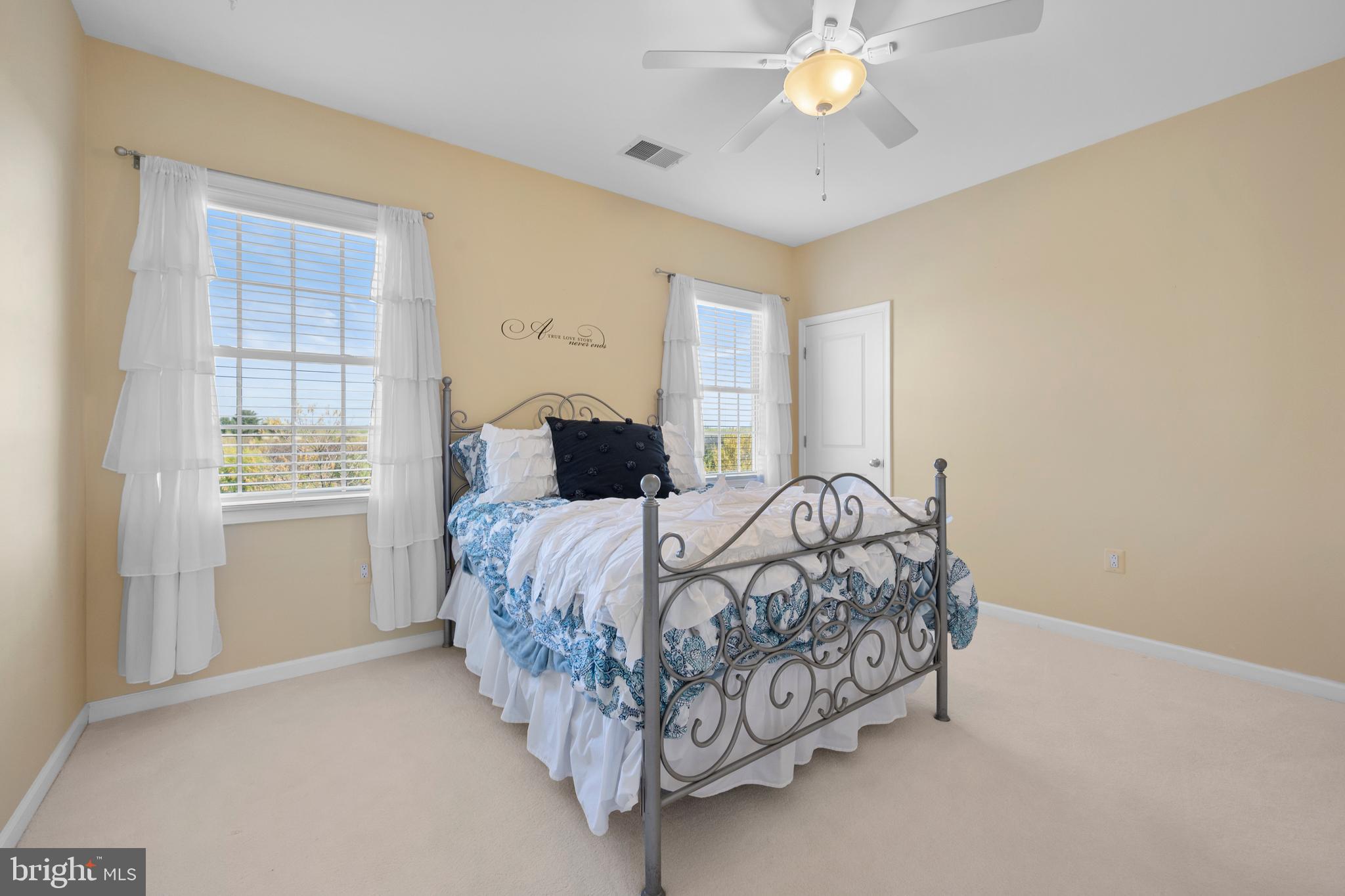 13212 Moonlight Trail Drive Silver Spring, MD 20906 - Photo 53 of 81 a bedroom with a bed and a chandelier