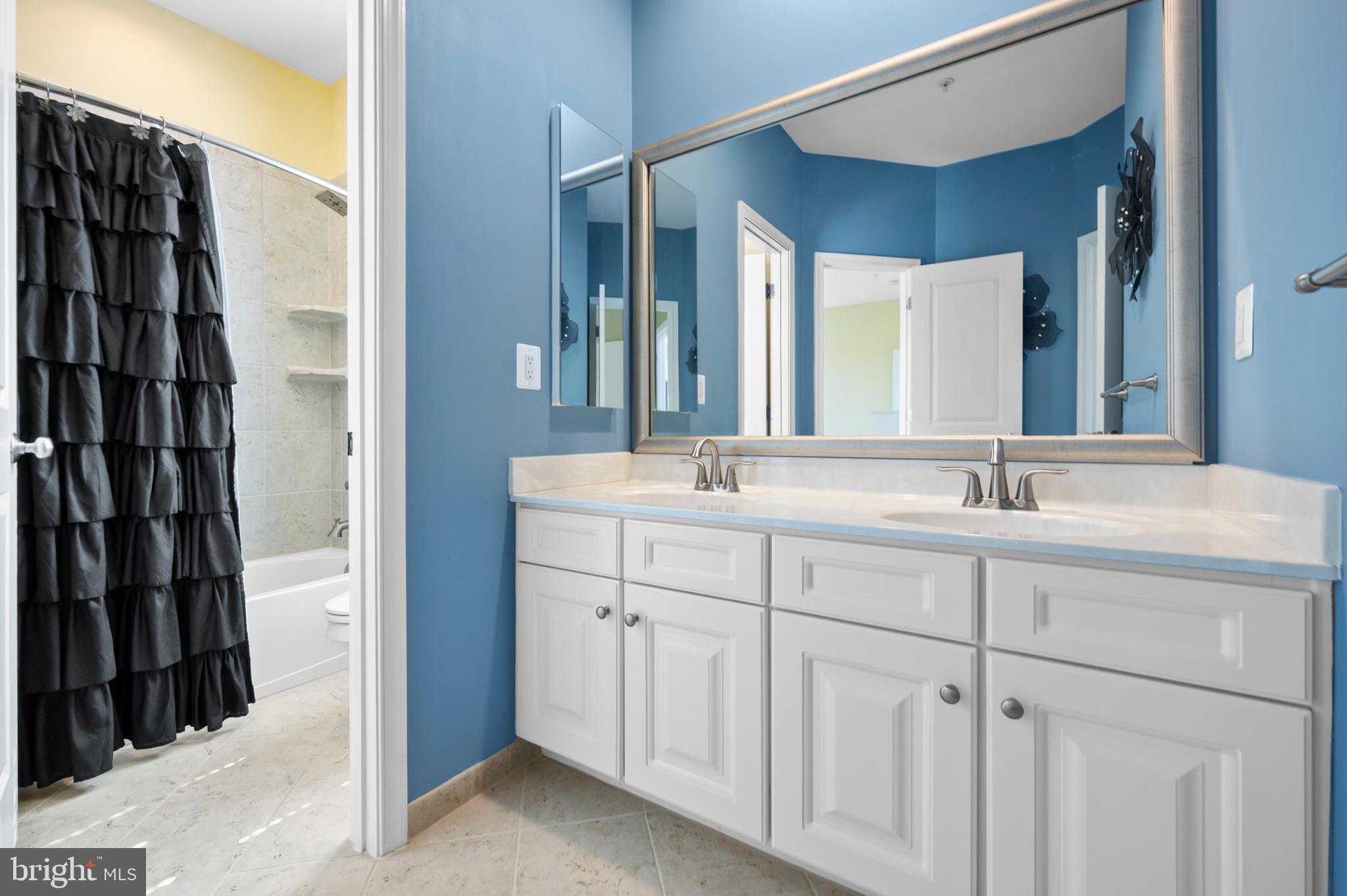 13212 Moonlight Trail Drive Silver Spring, MD 20906 - Photo 55 of 81 a bathroom with a double vanity sink and a mirror