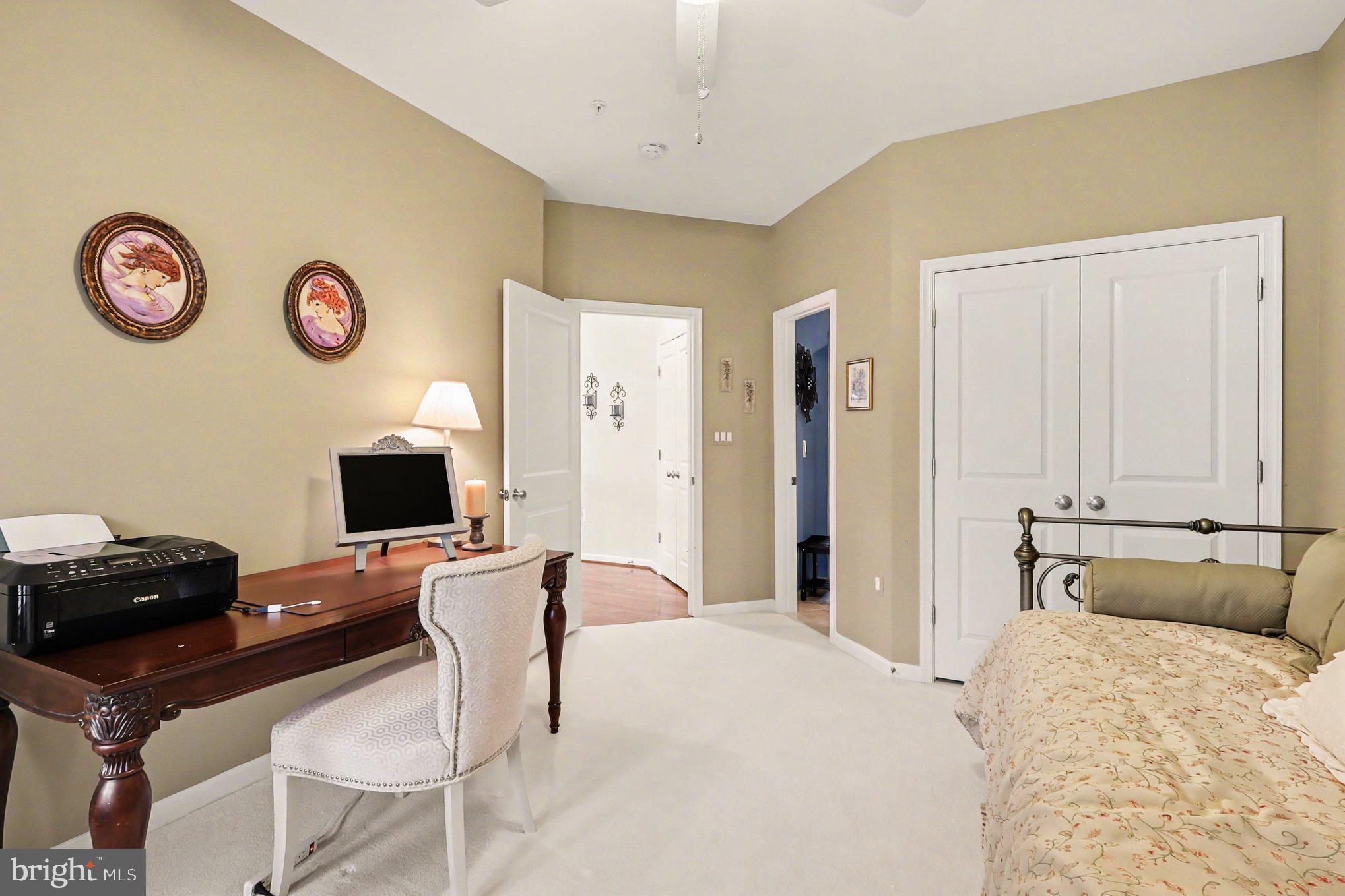 13212 Moonlight Trail Drive Silver Spring, MD 20906 - Photo 57 of 81 a bedroom with a bed and a chair with the bookshelf