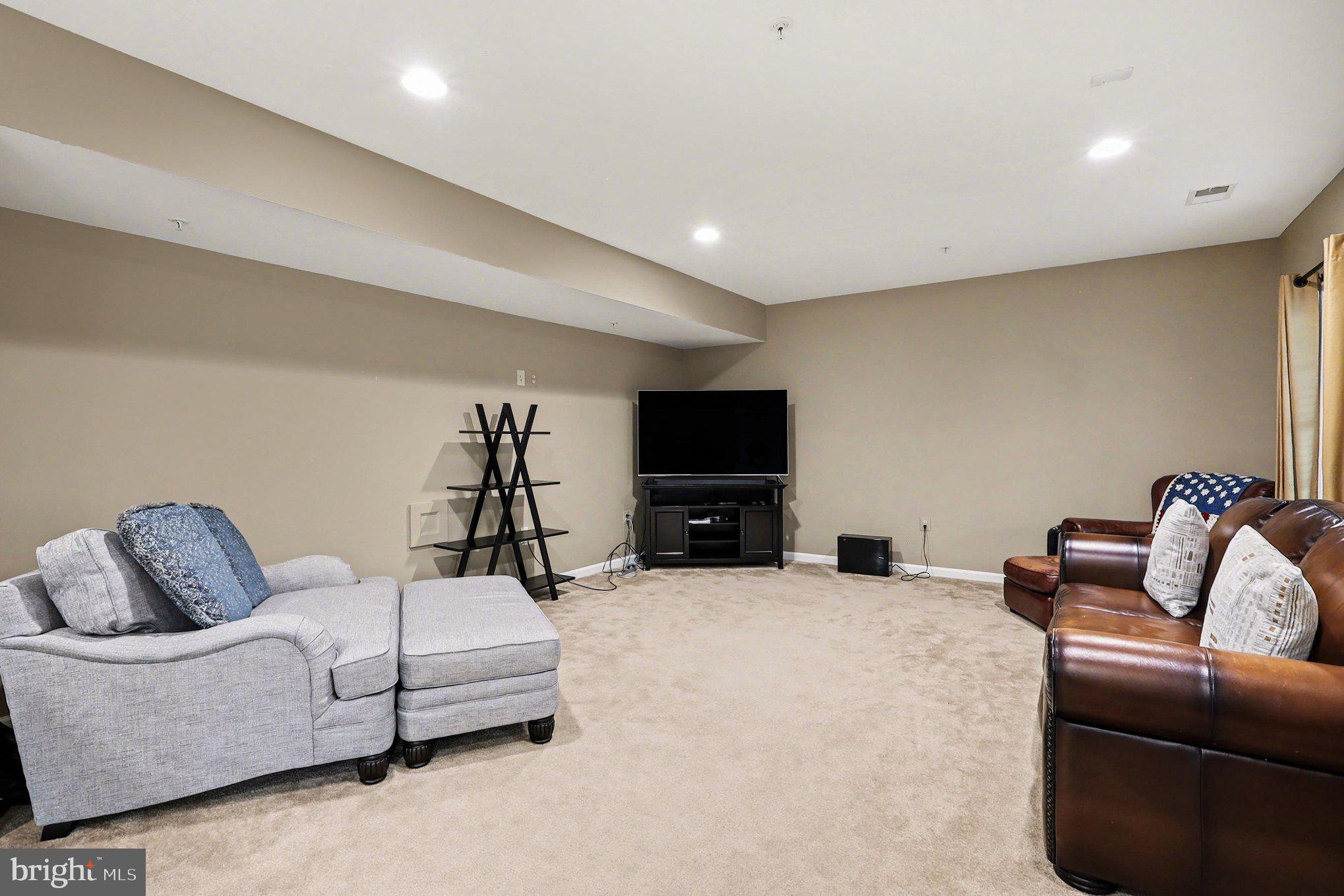 13212 Moonlight Trail Drive Silver Spring, MD 20906 - Photo 67 of 81 a living room with furniture and a flat screen tv