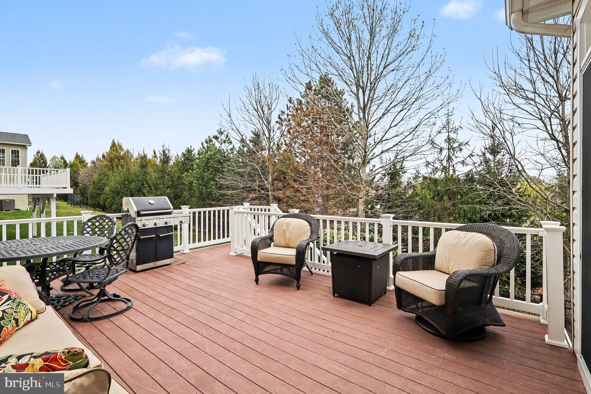 13212 Moonlight Trail Drive Silver Spring, MD 20906 - Photo 9 of 81 a view of a deck with furniture and trees in the background