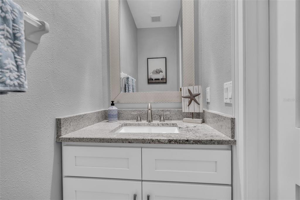 848 Evergreen Way Longboat Key, FL 34228 - Photo 12 of 66 a bathroom with a granite countertop sink and a mirror