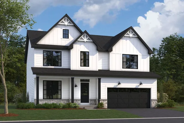 a front view of a house with garage and yard