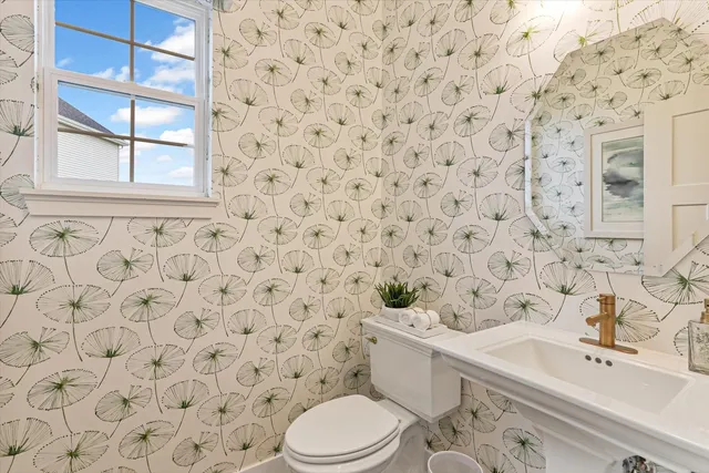 a white toilet sitting next to a shower curtain